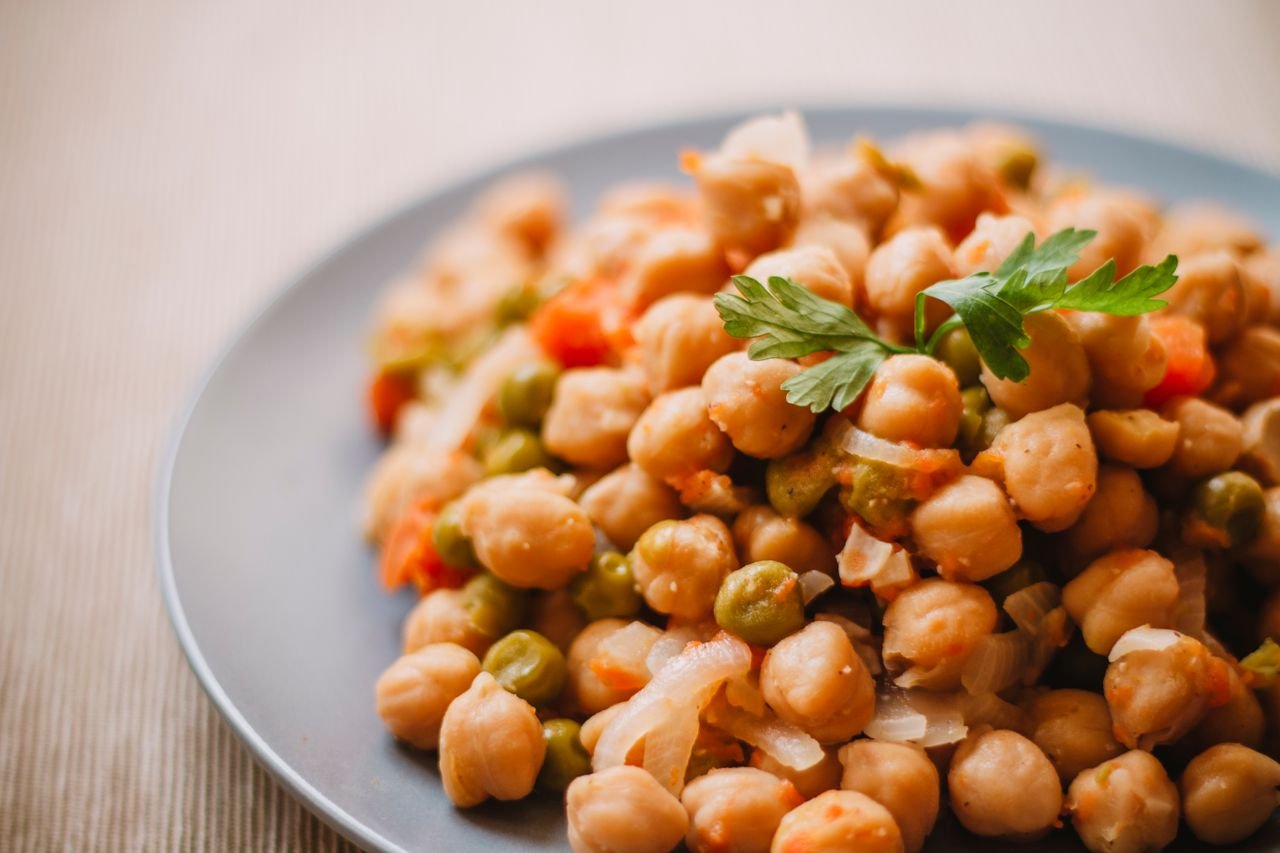 HOME A close-up of a nutritious chickpea and vegetable salad on a plate, perfect for healthy eating.